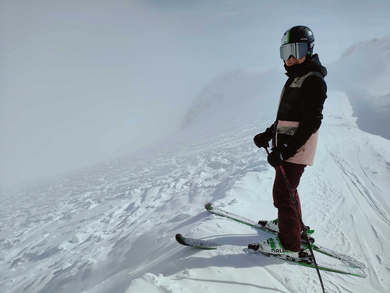 skier in a helmet on a snowy slope