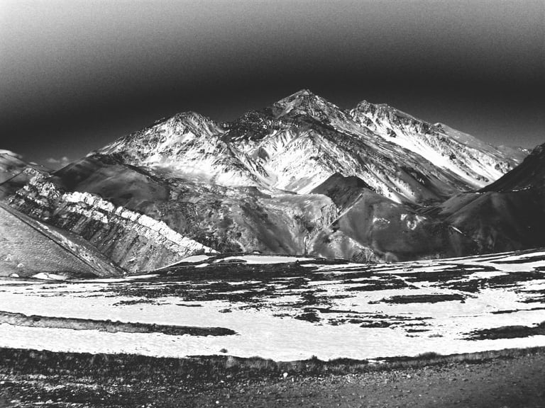 a black and white photo of a mountain range