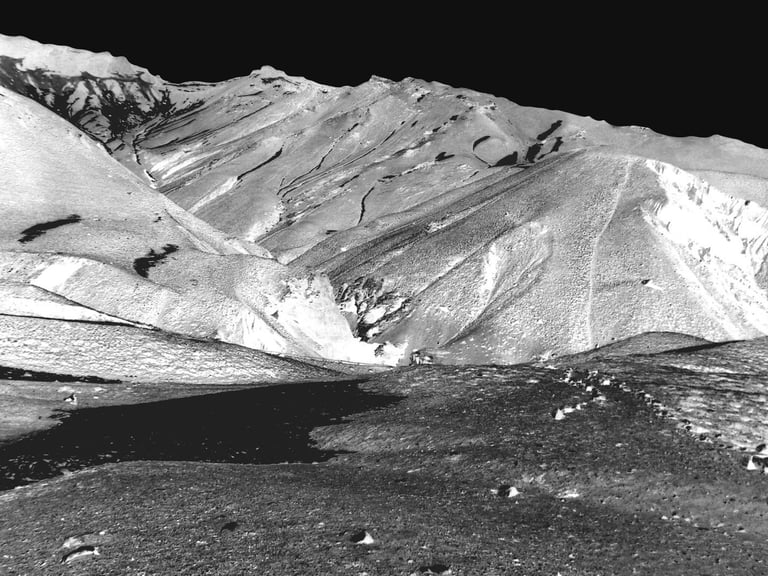 a black and white photo of a mountain range