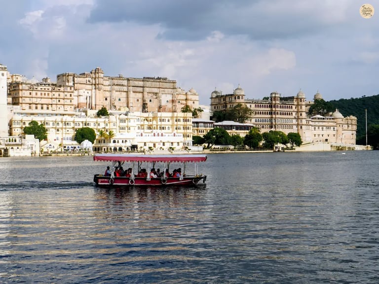 Boat ride on Lake Pichhola with City Palace Udaipur in the background.