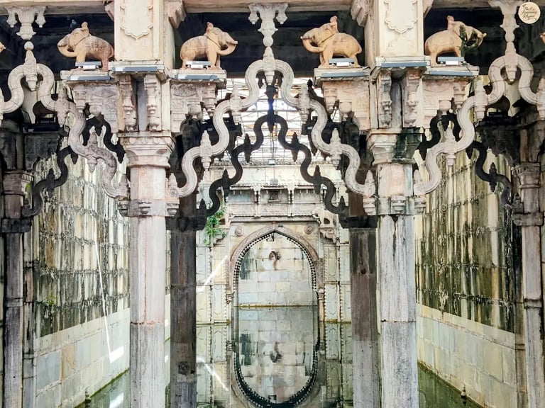 Ornate arches reflecting in the still waters of Rani Ji Ki Baori, Bundi — a mesmerizing play of stone and silence.