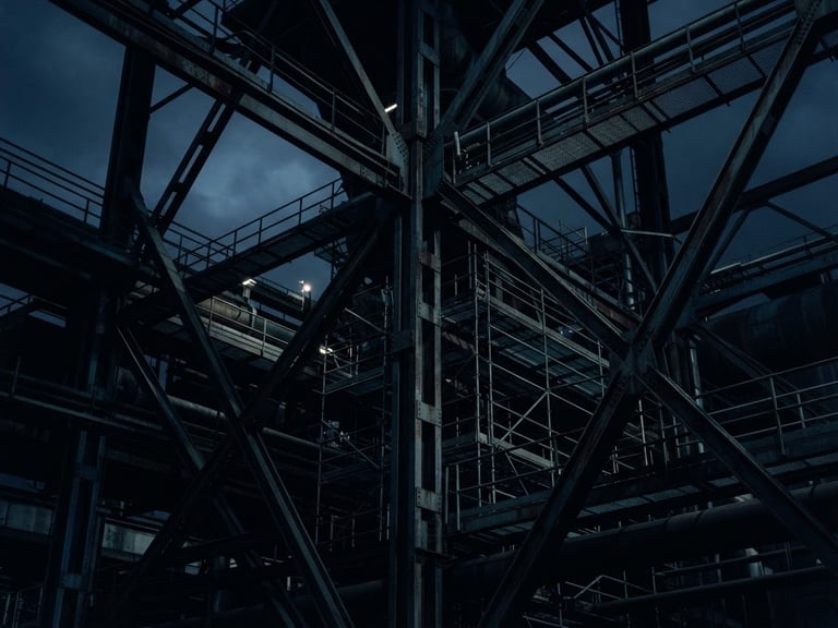 Abstract architectural geometry of steel industrial structures, dark blue and slate grey tones, sharp lines, dramatic low-key lighting, 35mm