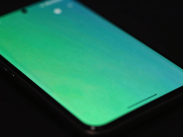 Macro close-up of a physical Android screen displaying fluid UI transitions, dark studio background, vibrant green and teal neon reflections, 35mm
