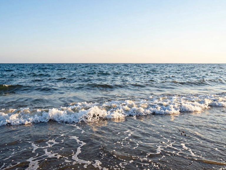 Warm golden hour light reflecting on the waves of the Romanian Black Sea coast, wide-angle environmental shot