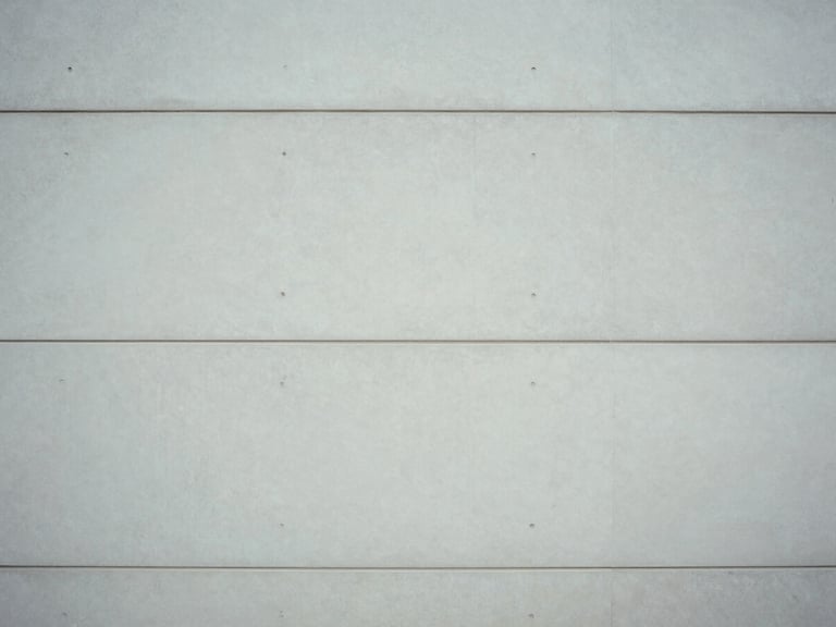 Minimalist architectural photography of clean concrete lines and soft overcast daylight shadows, 35mm sharp focus