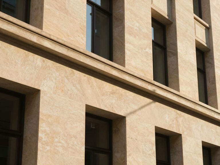 A close-up of a modern limestone architectural facade, clean linear shadows, warm golden hour sun, 35mm