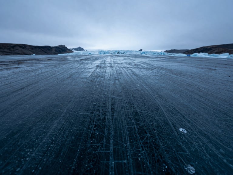 Extreme macro close-up of pure arctic glacier ice texture, fine frozen lines, cold blue light, high contrast