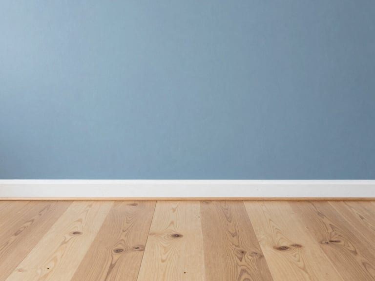 Crisp architectural detail of newly installed light oak flooring meeting a freshly painted slate blue wall, bright Seattle overcast daylight, sharp focus, 35mm