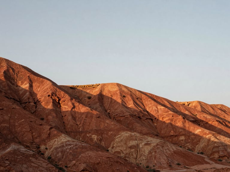 Wide panoramic low-angle shot of red clay mesa formations under a crisp overcast sky, sharp geological layers, medium format film.