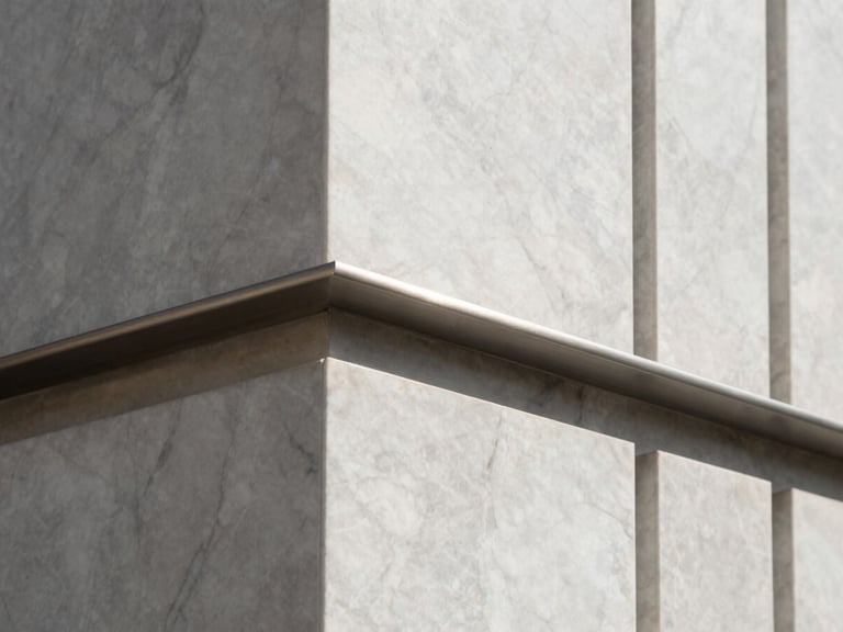 Close-up of honed marble and brushed steel architectural details, crisp high-contrast daylight, minimalist neutral tones, sharp focus, architectural render style