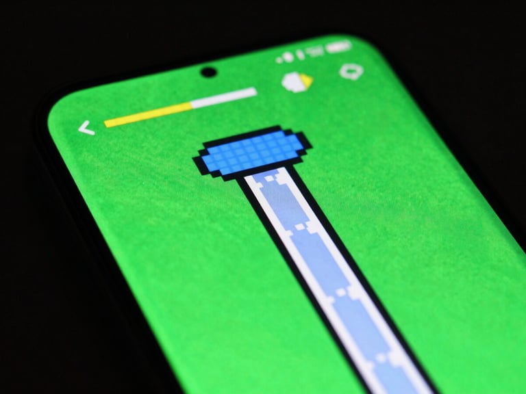 Macro shot of an Android phone screen displaying a vibrant pixel art endless runner game, high-contrast studio lighting with green backlight, sharp focus.
