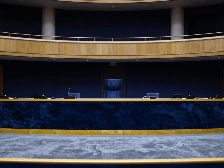 Wide environmental portrait of an empty, elegant European ministerial hall, high-contrast lighting, navy and gold accents.