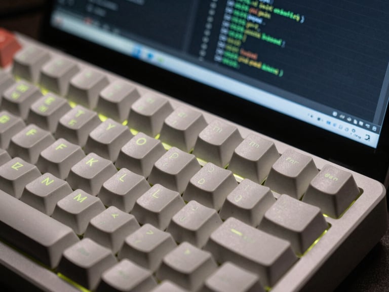 Macro shot of a clean mechanical keyboard and a high-resolution screen showing structured code, low-key ambient lighting with subtle electric lime LED glows, sharp focus, technical aesthetic.