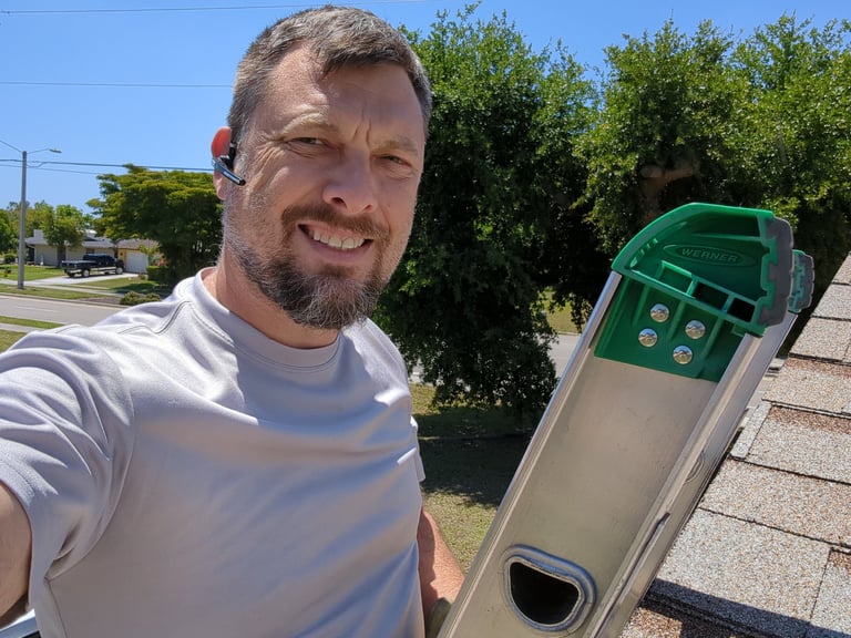 Dryer vent cleaner on a ladder