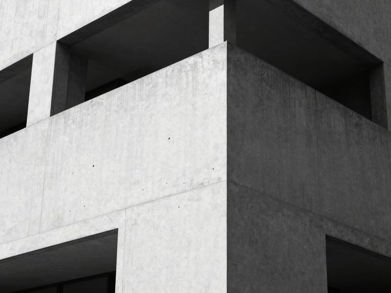 High-contrast black and white photograph of a minimalist concrete building corner, sharp geometric shadows, clean architectural lines, 35mm lens.