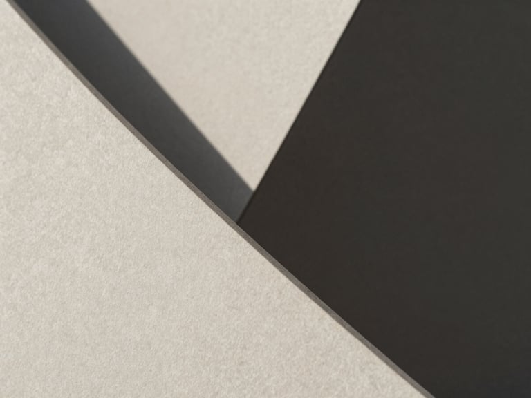 Macro close-up of sharp architectural concrete folds with hard diagonal shadows, minimalist composition, neutral tones, 50mm