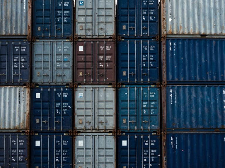 Crisp documentary photography of stacked shipping containers at Apapa port under high-contrast daylight, deep industrial blues, 35mm.
