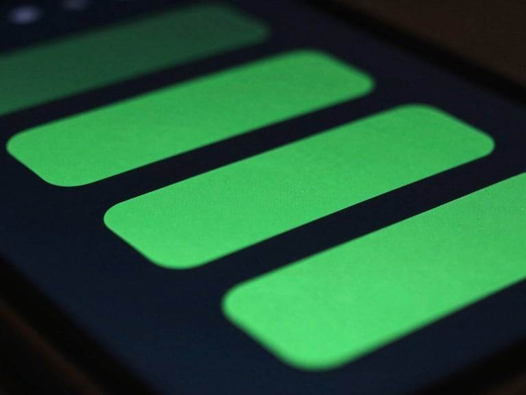 Extreme close-up macro shot of a high-resolution Android screen displaying glowing green fluid UI animations, low-key atmospheric studio lighting, 35mm.