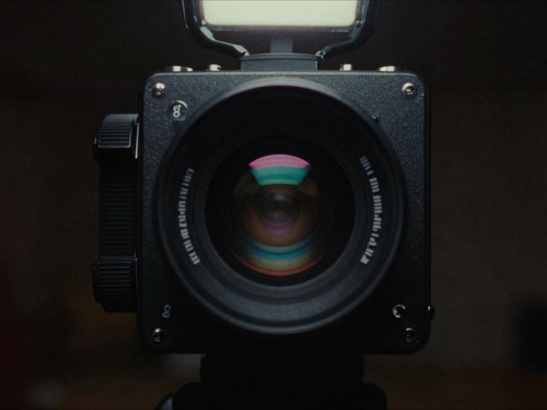 High-contrast still from a 90s action movie, gritty aesthetic, dramatic backlighting, analog film grain, cinematic film photography, low-key neon lighting, retro synthwave color palette, heavy analog film grain, 35mm lens