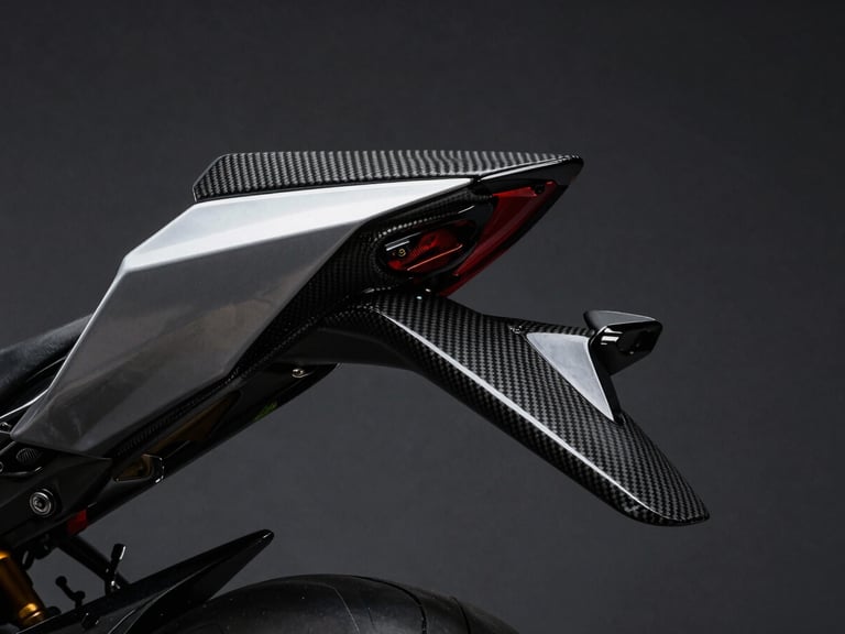 Low-angle shot of a carbon fiber motorcycle winglet and aerodynamic fairing catching sharp side-lighting