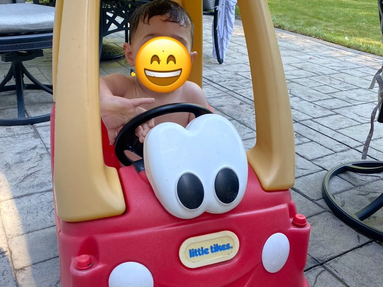 Toddler playing with Little Tikes Coupe