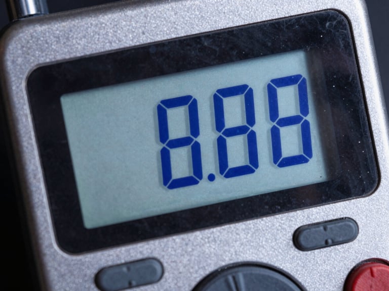 Close-up of a digital power meter display showing crisp blue LED readouts, high contrast studio lighting, sharp details.