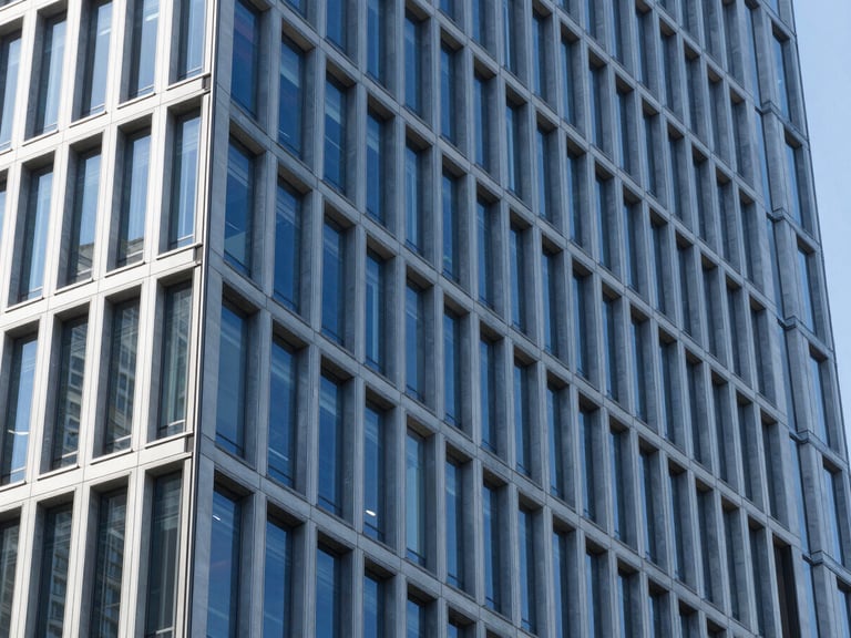 Architectural detail of a modern business district building, geometric patterns, bright natural light, deep blues and cool tones, sharp focus, 35mm lens