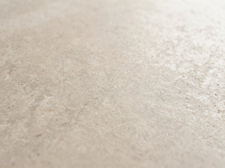 Macro shot of a natural stone texture, emphasizing organic patterns, soft morning light, warm minimalist tones.