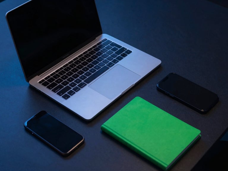 Overhead view of a sleek productivity-focused desk setup with a laptop, notebook, and smartphone, cool blue ambient light, sharp focus.