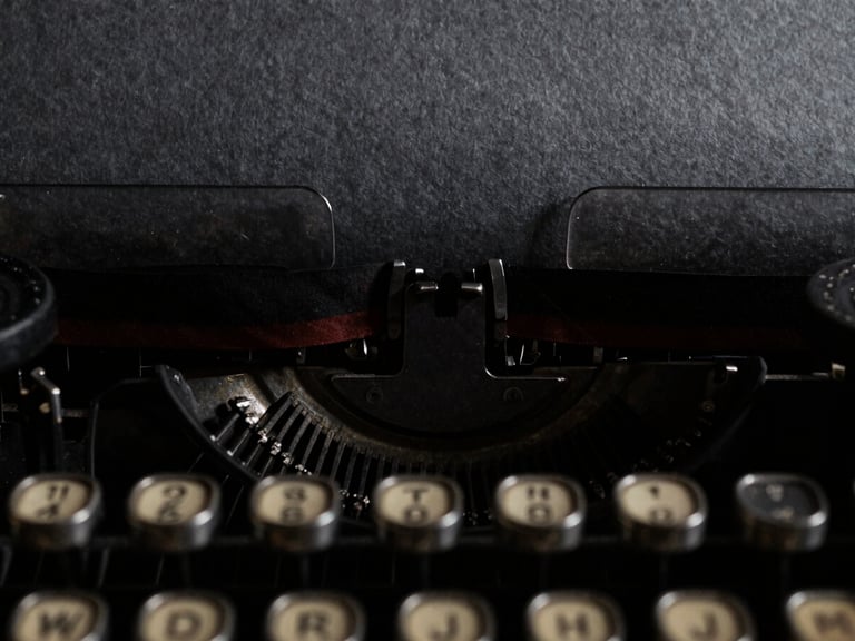 Extreme close-up of vintage typewriter keys striking textured charcoal paper, deep shadows, chiaroscuro lighting, 35mm film grain