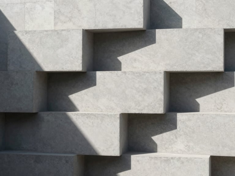Minimalist composition of raw concrete blocks stacked under sharp sunlight, deep architectural shadows, clean lines, premium material texture