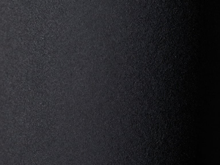 Macro close-up studio shot of dark grey Alcantara fabric texture, soft matte finish, emphasizing tactile feel, moody lighting, 50mm