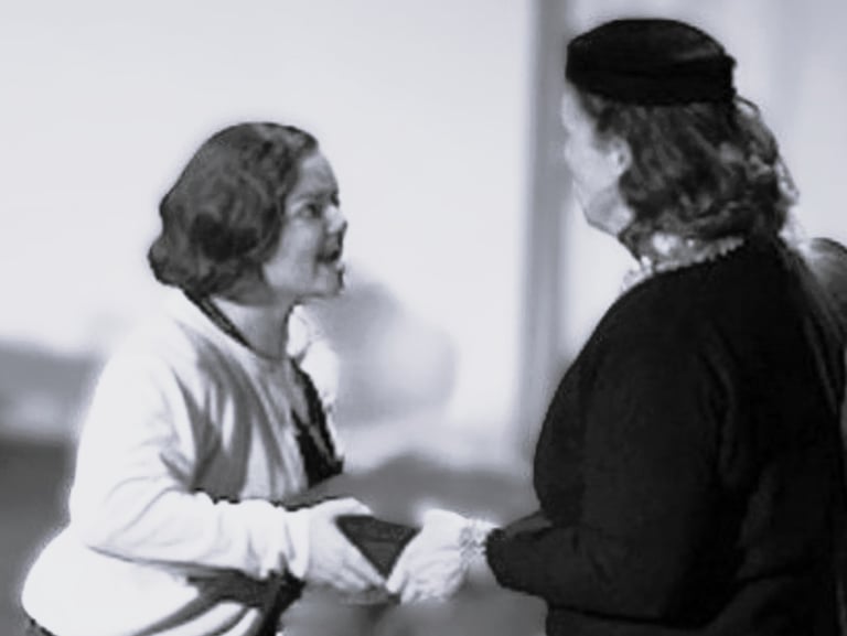 Two women, one young, one older, tussle over a box, each trying gain possession of it.