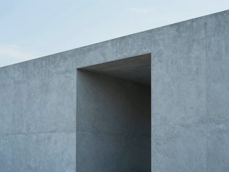 Minimalist concrete architectural structure with clean lines and geometric shadows in cool diffused daylight