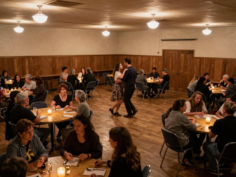 Wide shot inside a small-town community hall set up for a dance, tables with candles, warm tungsten overhead lights, people beginning to arrive, candid and immediate