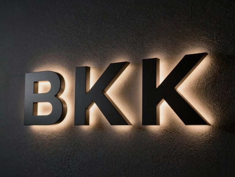 Backlit 3D letters mounted on a dark textured wall, casting a soft halo glow