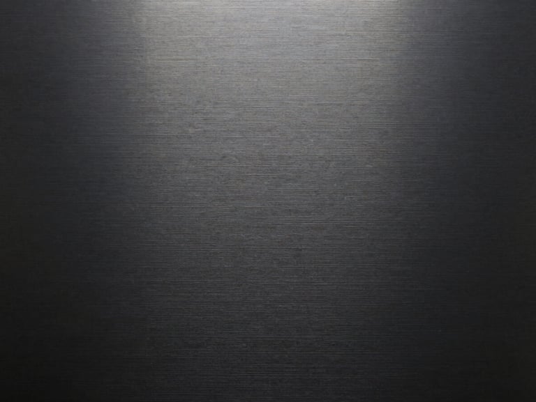 Macro texture of dark brushed metal with clean horizontal grain, high-contrast overcast lighting.