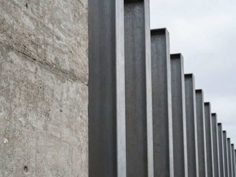 Macro texture of raw structural concrete and steel pillars, sharp architectural lines, overcast daylight.