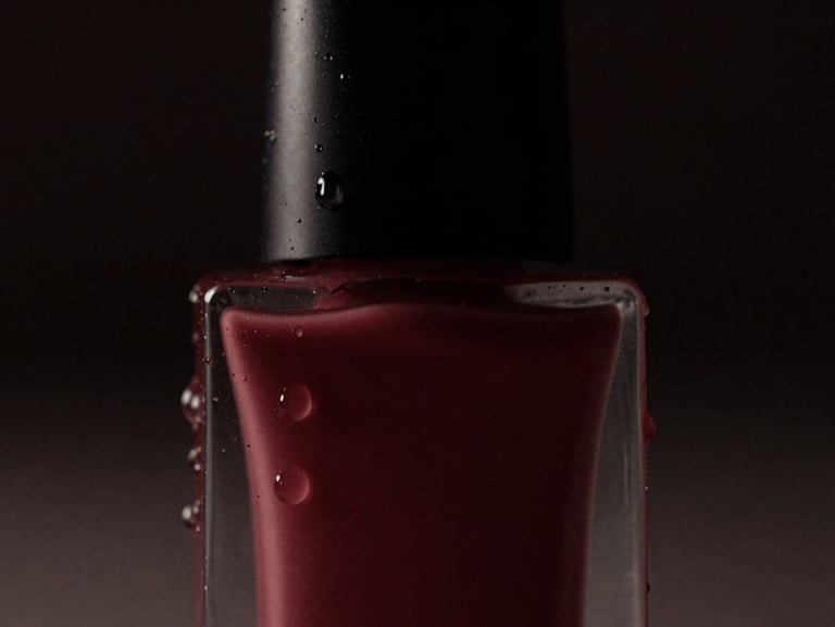 Moody cinematic close-up of a premium cosmetic bottle with water droplets, dramatic low-key studio lighting, deep shadows, dark charcoal and wine-red tones, 35mm