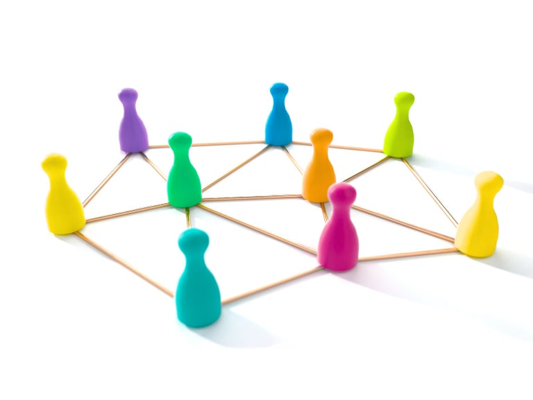 a group of colorful colored board game pawns in a circle connected by golden lines