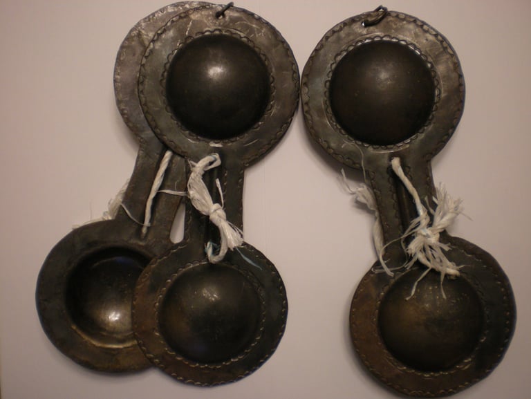 a pair of antique metal spoons with a pair of spoons