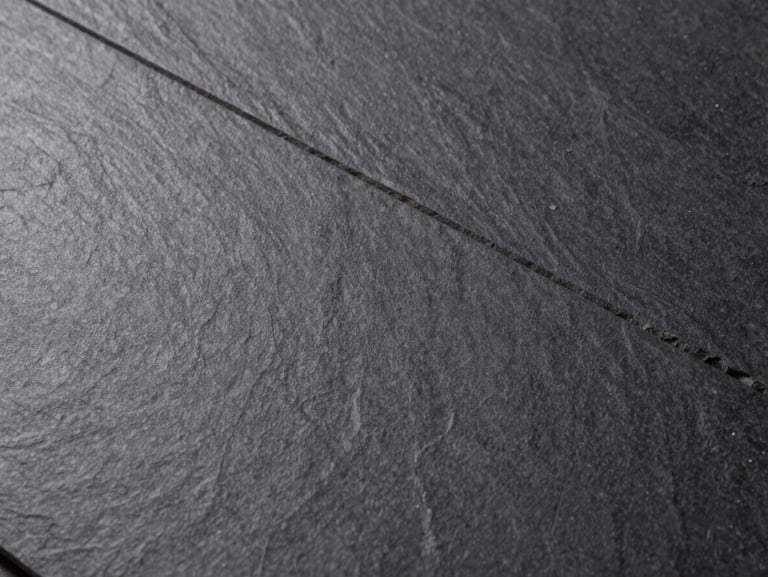Close-up of sophisticated dark slate SPC tile, showcasing realistic stone texture and matte finish.