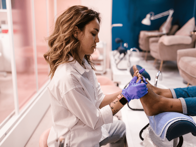 nail technition massaging customers feet