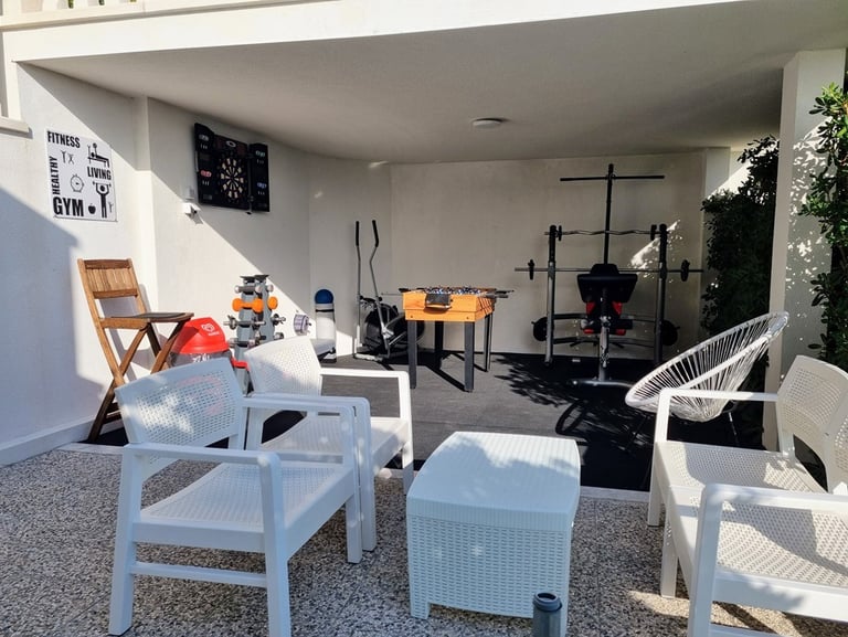 The photo shows an outdoor Fun and Fitness area with home equipment.