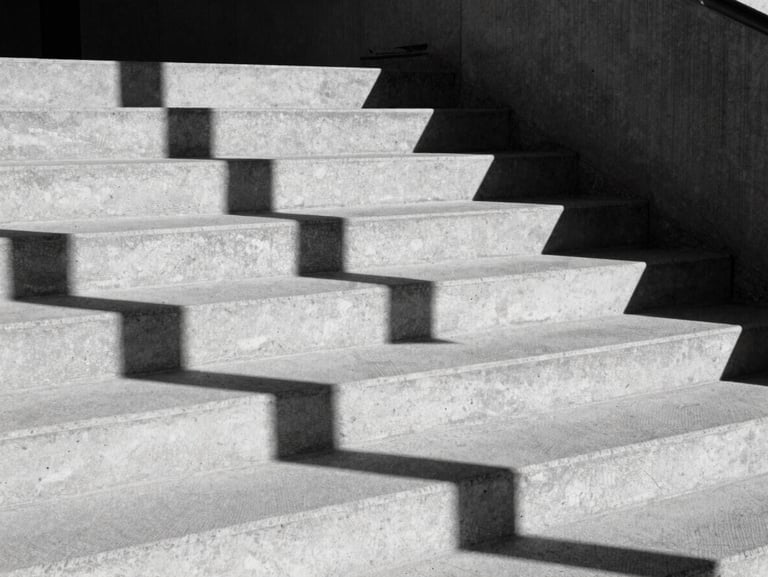 Abstract architectural shadows on a raw concrete staircase, direct midday sunlight, stark black and white composition, heavy grain.
