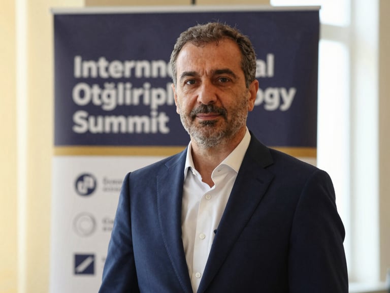Medium close-up portrait of Dr. Öğretmenoğlu in a tailored navy suit, standing confidently in front of an international ophthalmology summit banner, warm lighting.