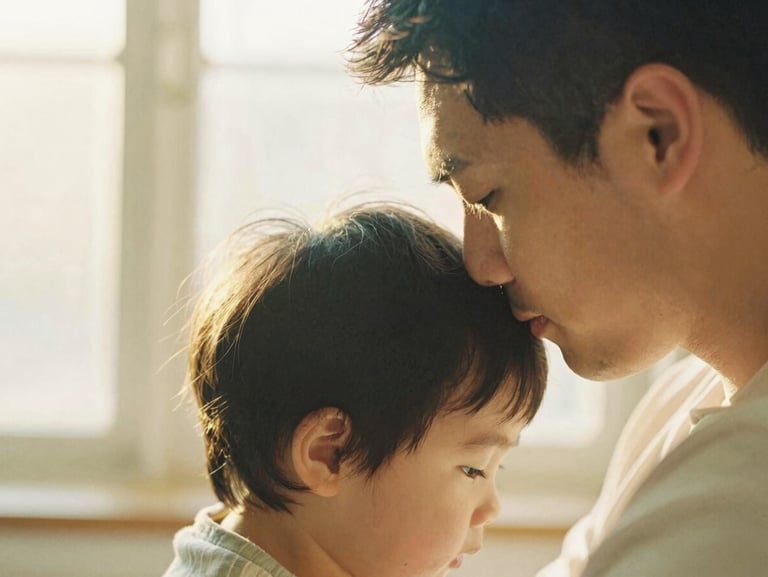 A father gently resting his forehead against his child's head, soft textures, warm golden hour glow, shallow depth of field.