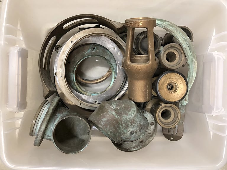 Metal parts in a sculptor's workshop bin, image 6.