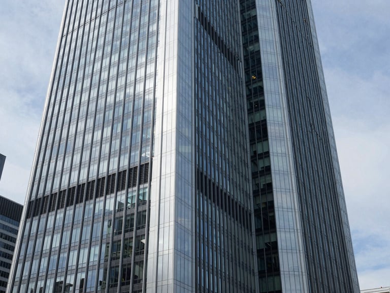 Sleek, modern skyscraper in Frankfurt's financial district, reflecting the sky, clean architectural lines, professional corporate photography, cool natural daylight.