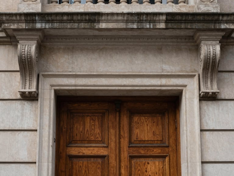 Limestone brownstone entry detail, carved stone lintels, heavy oak double doors, soft overcast daylight